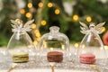 Three macaroons under decorative glass cover