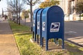 Three mailboxes on a city street