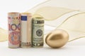 Three major currencies with gold egg Royalty Free Stock Photo