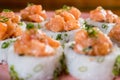 Three maki rolls in a row with salmon, eel and cucumber isolated on white background. Fresh hosomaki pieces with rice Royalty Free Stock Photo