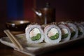 Three maki rolls in a row with salmon, eel and cucumber isolated on white background. Fresh hosomaki pieces with rice Royalty Free Stock Photo