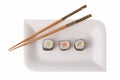 Three makizushi sushirolls and chopsticks