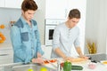 Three male friends making pizza in kitchen together Royalty Free Stock Photo