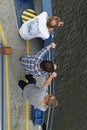 Three Male Passengers standing at the edge of the deck of an Offshore Supply Vessel