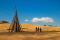 Three male tourists are walking along the Mongolian steppe