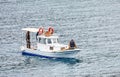 Three male Turkish fisherman on a white traditional fishing boat sailing over the sea in Gumusluk, Bodrum, Turkey