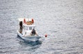 Three male Turkish fisherman on a white traditional fishing boat sailing over the sea in Gumusluk, Bodrum, Turkey