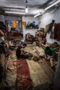 Three male workers working at an old carpet store, Istanbul, Turkey