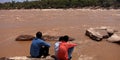 Three man seating together around river bank Royalty Free Stock Photo