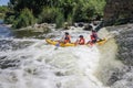 Three man white water kayaking on the river, extreme and fun sport at tourist attraction. Royalty Free Stock Photo