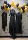 three mannequins in black dresses with balloons