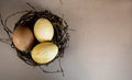 Three marble blue Easter eggs painted by hibiscus, in a nest on a wooden background close-up. The Symbol Of Easter Royalty Free Stock Photo