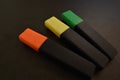 Three markers on a black background. Royalty Free Stock Photo