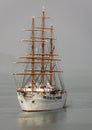 THree masted sailing cruise ship emerging from the mist