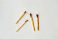 Three matches are lined up in a row on a white surface Royalty Free Stock Photo