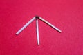Three matches in the shape of an arrow on a red background Royalty Free Stock Photo