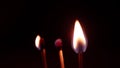 Three matches sticks burning together on a black background Royalty Free Stock Photo