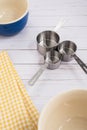 Three measuring cups and mixing bowls on a wood top Royalty Free Stock Photo