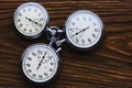 Three mechanical stopwatches on a wooden background
