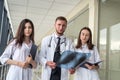 Three medical intern looking through x-ray image of lungs for viral pneumonia of Covid-19 patient in clinic Royalty Free Stock Photo