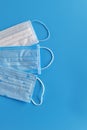 Three medical protective mask isolated on blue background