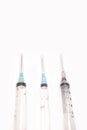 Three medical syringe closeup on white background isolated Royalty Free Stock Photo
