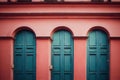 Three medieval arch door made of turquoise wood in red wall.