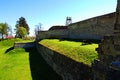 Three medieval cannons on green grass in front of the defensive wall. Ancient fortifications of the Zbarazh castle Royalty Free Stock Photo