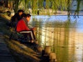 Three men fishing in lake Royalty Free Stock Photo