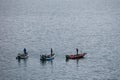 three men are fishing at the small motor boat in Kawaguchiko lake, Japan Royalty Free Stock Photo