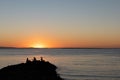 Three men fishing during sunset Royalty Free Stock Photo