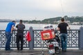 Three Men Fishing wiht Three Rods on Galata Bridge in Early Morn Royalty Free Stock Photo