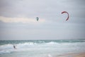 Three men kitesurfing on the beach in Indian ocean in Perth