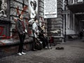 Three men music band playing and singing on the street