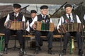 Three men playing accordion