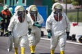 Three men in protective gear disinfecting contaminated areas Royalty Free Stock Photo