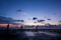 Three men running on jack up oil rig helipad Royalty Free Stock Photo