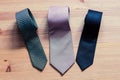 Three men`s tie rolled into a roll on a wooden background Royalty Free Stock Photo