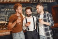 Three men in shirts in the bar. Royalty Free Stock Photo