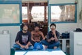 Three men sitting in the boat at docks area Royalty Free Stock Photo