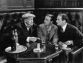 Three men sitting together at a bar Royalty Free Stock Photo