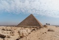 three men walking towards Keops\' pyramid. El Cairo Egypt