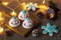 Three meringue snowmen on a serving board