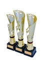 Three metal award cups of different height of gold color