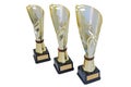 Three metal award cups of different height of gold color