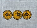 Three metal badges with the image of the an ancient athletes and the inscription `Olympic Games of Ancient Greece`