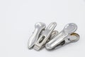 Three metal cloth clips on white background