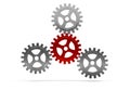 Three metal cogwheel gears attached to a central red wheel over white background, teamwork, connection or communiaction abstract Royalty Free Stock Photo