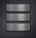 Three metal plates over grid background