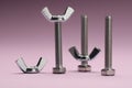 Three metal screws with wing nuts on purple background Royalty Free Stock Photo